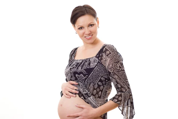 Красивая беременная женщина стоит — стоковое фото