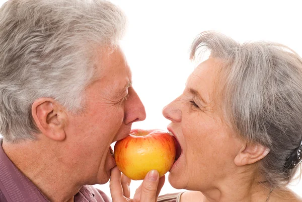 stock image Nice elderly couple eating an apple