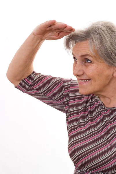 Senior woman shielding her eyes — Stock Photo, Image