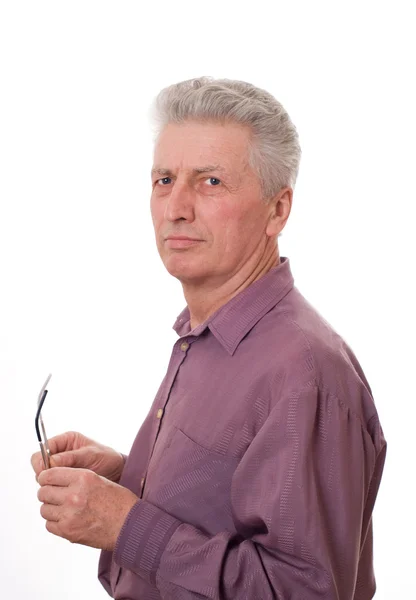 Älterer Mann hält Brille auf weißem Grund — Stockfoto