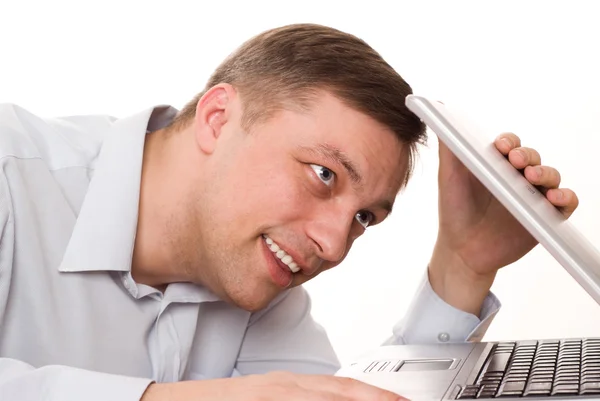 Young man looks at a laptop — Stock Photo, Image