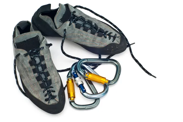 Carabiners and climbing shoes — Stock Photo, Image