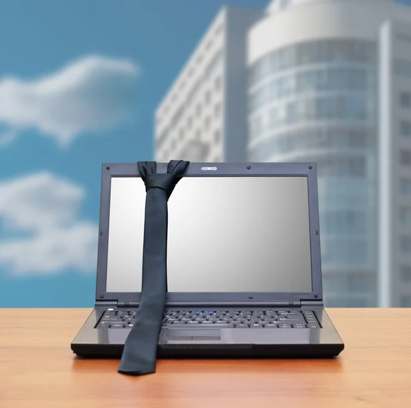 Ноутбук, галстук в интерьере офиса — стоковое фото