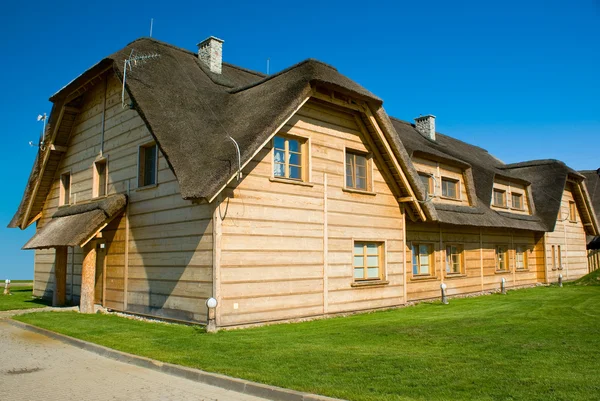 stock image Big wooden house with straw roof