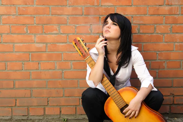 Femme avec une cigarette et une guitare — Photo