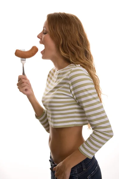 Girl eats sausage — Stock Photo, Image