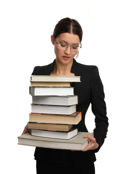Flicka som håller en stor hög med böcker — Stockfoto