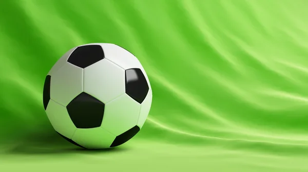 Bola de futebol em um fundo verde — Fotografia de Stock