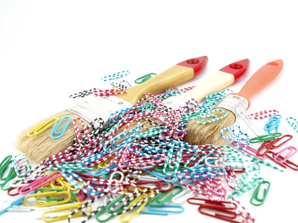 Paint brushes and striped clips — Stock Photo, Image
