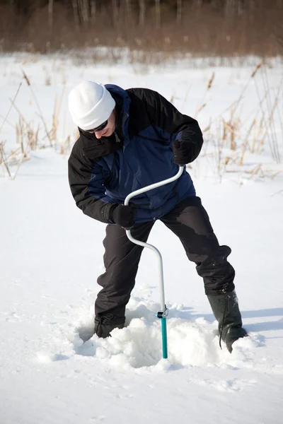 stock image Fisherman with ice-drill