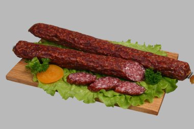 Smoked sausage on wooden board 2 clipart