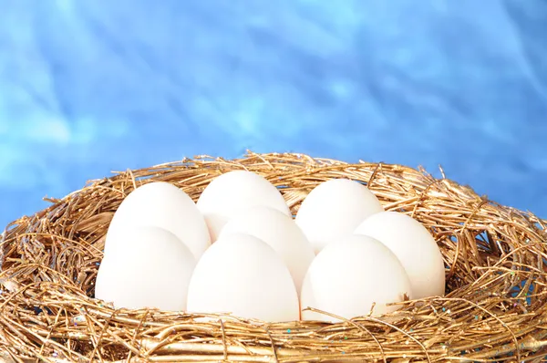 Bílá vejce v hnízdě zlatý — Stock fotografie