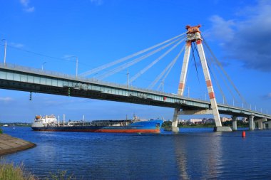 Oil tanker under the cable-stayed bridge clipart