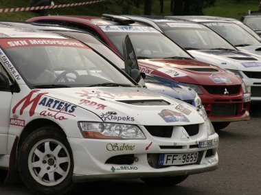 Rally cars parked in a row. clipart