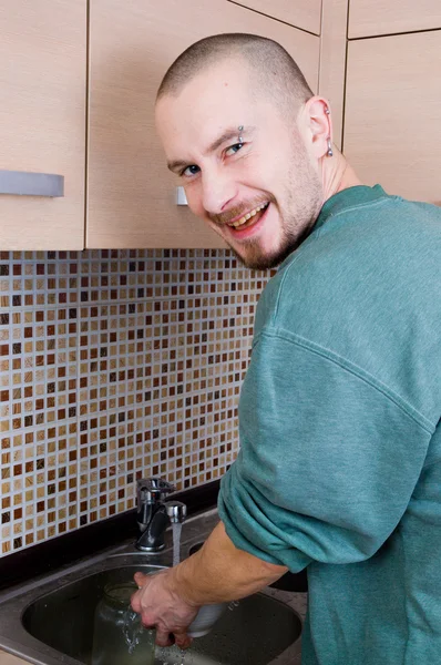 stock image Man washes dishes