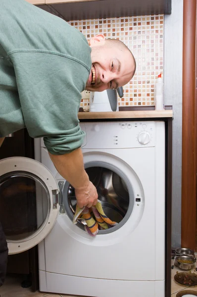 Stock image Man and a washing machine