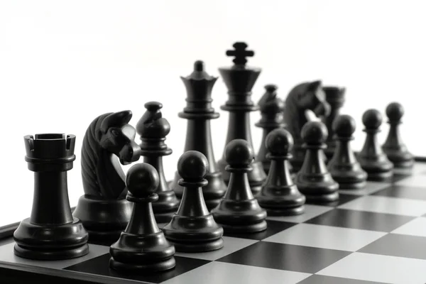Black chessmen on a chessboard — Stock Photo, Image