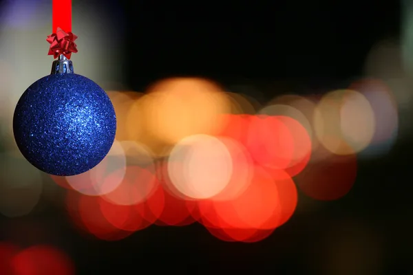 Christmas ball against bluring light — Stock Photo, Image