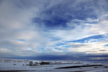 Dramatic sky in rural area in winter sea clipart