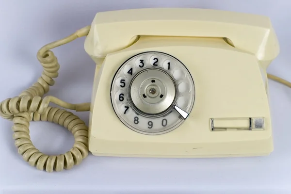 Téléphone rétro jaune isolé sur un blanc — Photo