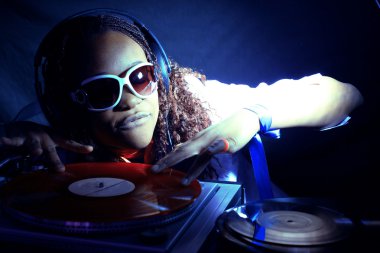 Cool afro american DJ in action clipart