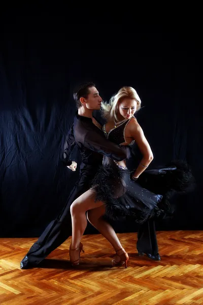 Dancers in ballroom against black — Stock Photo, Image