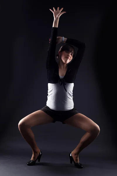 Woman modern dancer against black — Stock Photo, Image