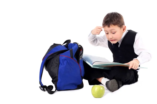 Školák s knihou a jablko — Stock fotografie