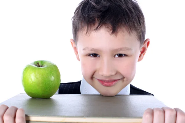 Школярка з книгою та яблуком — стокове фото