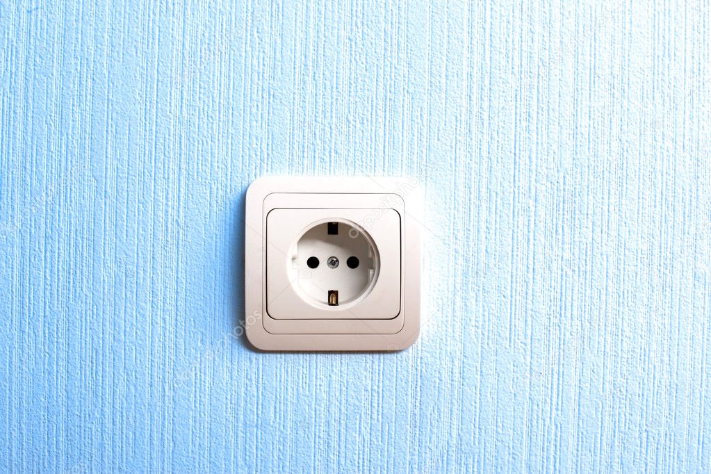 Electric plug connector in blue wall