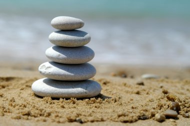 Pebble stack on the seashore clipart