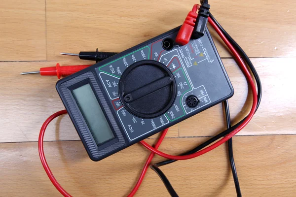 Modern multimeter at table — Stock Photo, Image