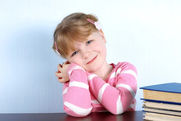 Little girl with apple and books — Stock Photo, Image
