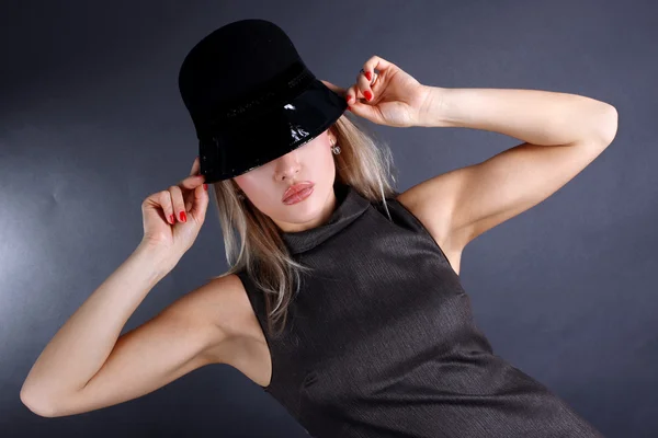 Fashion young woman in hat hiding eyes — Stock Photo, Image