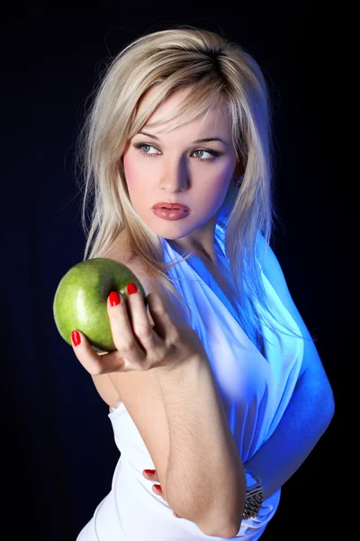 Girl with apple under blue light — Stock Photo, Image