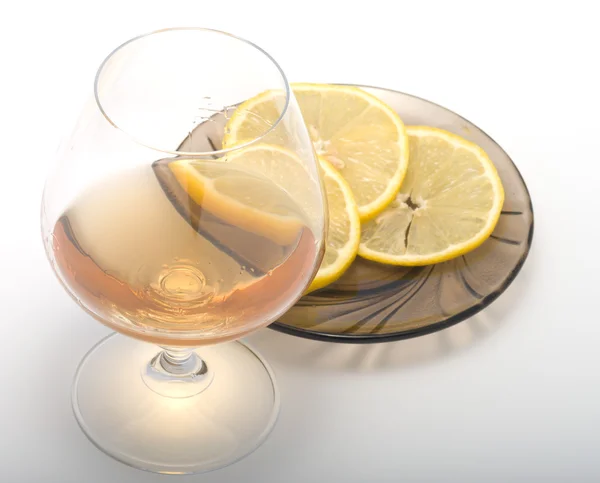 Cognac and lemon. — Stock Photo, Image