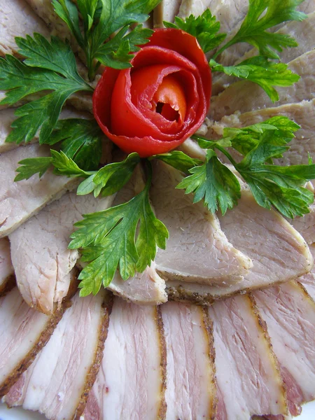 Cold baked pork decorated with tomato — Stock Photo, Image
