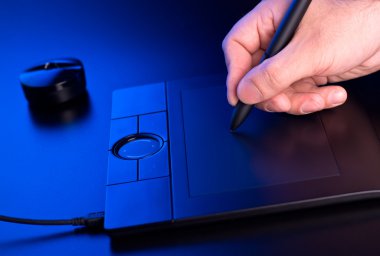 Man's hand draws on graphic tablet clipart