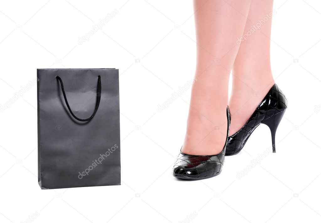 Women legs in varnished shoes stand behi