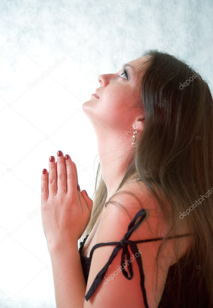 Young woman praying to god