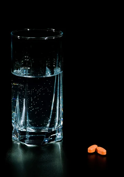 Two pills and glass of water — Stock Photo, Image