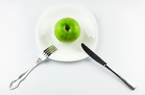 Villát, kést, zöld alma a fehér edény — Stock Fotó