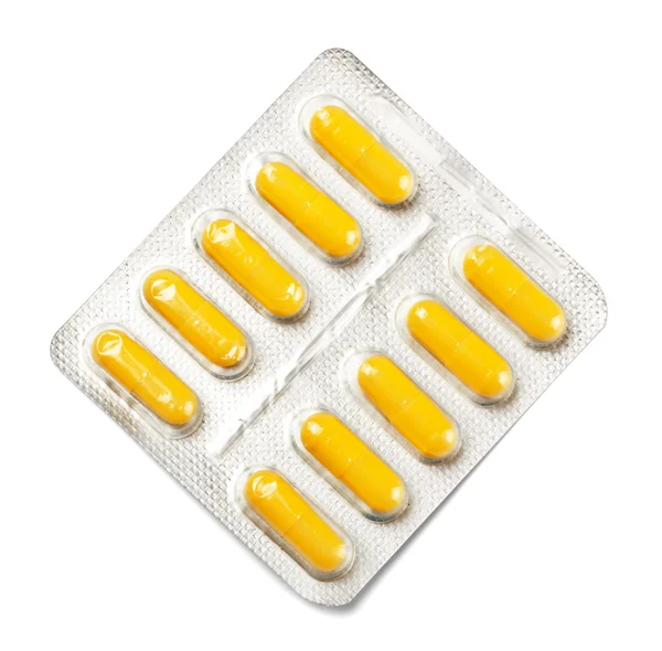 Paket mit gelben Kapseln — Stockfoto