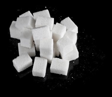 Pieces of sugar on black clipart