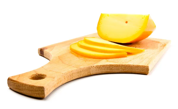 Cheese slices on cutting board — Stock Photo, Image