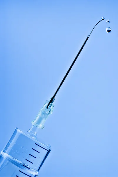 Syringe with drops on needle — Stock Photo, Image