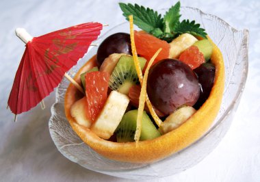 Fresh fruits salad in a grapefruit skin clipart