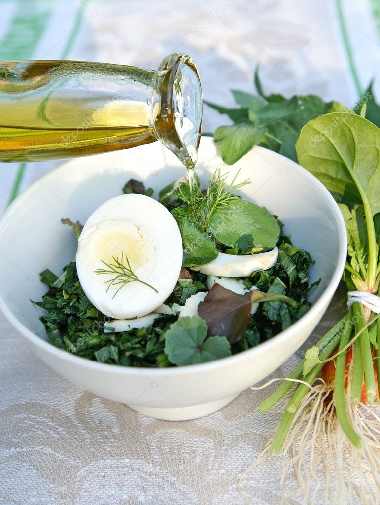 Spring weeda salad dressed with olive oi