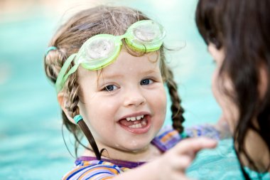 Family have rest in swimming pool. clipart