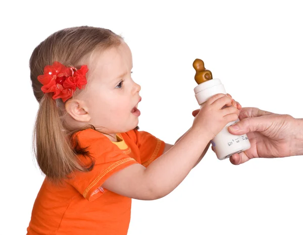 Child take small bottle with milk and d — Stock Photo, Image